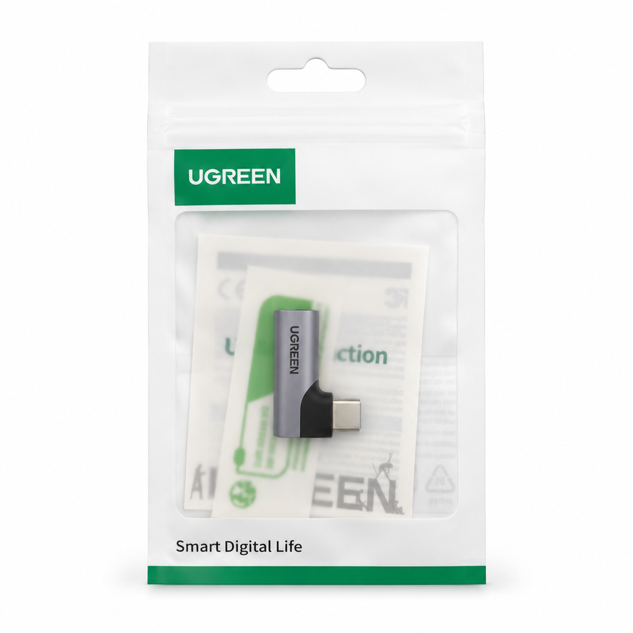 Adaptador UGREEN 20194 CM460 USB-C a 3.5 mm gris en ángulo recto, sobre fondo blanco